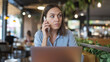 © Ozgurluk Design - Woman Talking on Phone in Cafe with Laptop