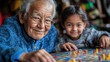© ATVPEDIA ID - An elderly man and a young girl enjoy a board game together, sharing a joyful moment.