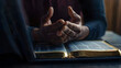 © Daniel - Hands together in prayer for god blessing to wish to have a better life. man hands praying to god with the bible on his laptop. believe in goodness. spirituality and religion, and bible prayer online