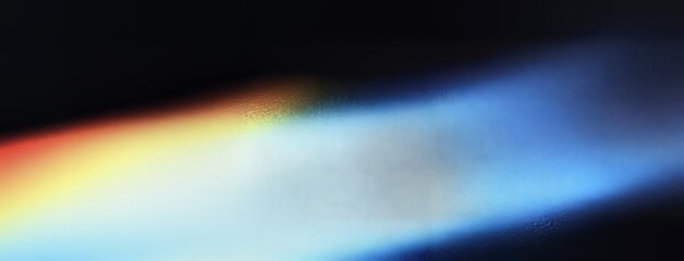 Poster - A dark poster background with a noisy texture, highlighted by glowing shapes in yellow, orange, and blue, with a grainy noise pattern, banner wallpaper design, and space for text.