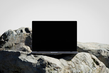 Wall Mural - scene with a opened laptop with a blank screen on the rock