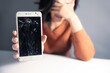© ARAMYAN - young woman with broken smartphone