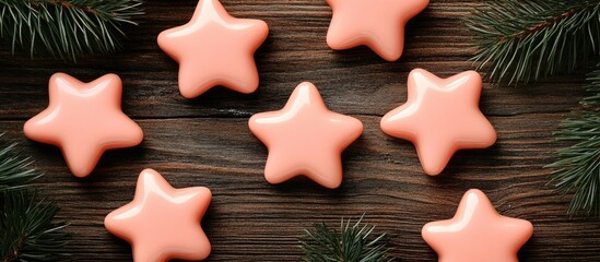 Poster - Pink star Christmas ornaments surrounded by pine branches on a rustic wooden background with ample space for festive text or messages