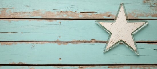 Poster - Glass Christmas star decoration on rustic painted wooden background for festive holiday themes