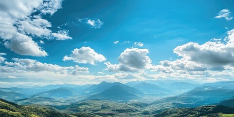 Wall Mural - Scenic view from a vantage point to majestic mountains, with fluffy clouds adorning the sky, creating a picturesque landscape that showcases the beauty of nature and surroundings.