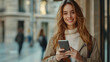 © Teko - Smiling Woman Using Smartphone, City Background Photo
