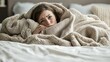 © S@photo - Person Relaxing in Bed Wrapped in Soft Blankets