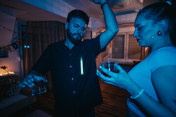 Poster - A scene from a vibrant birthday celebration showing friends dancing and enjoying drinks in a warmly lit room.