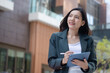 © Leny Studio - Senior asian businesswoman working , Remote work for anywhere outdoors professional content urban environment motivational concept, female worker enjoys telecommuting, balancing work from anywhere