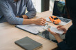 © Kritdanai - Auto Loan Consultation:  A close-up shot of a financial advisor and client reviewing car loan documents, signifying trust and financial planning.