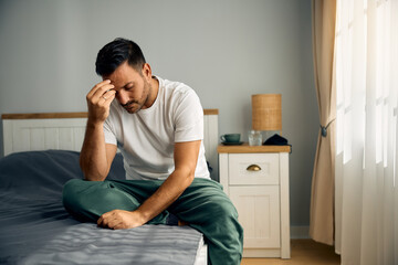 Wall Mural - Mid adult man feeling depressed in morning.