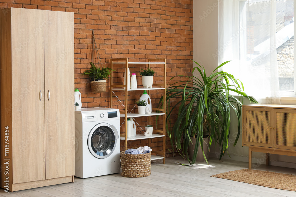 Interior of laundry room with washing machine, basket and shelf unit