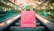 © blackdiamond67 - close-up of pink paper designer bag of new clothing on the escalator in a empty shopping