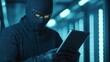 © anong - A masked figure in a dark setting uses a tablet, illuminated by blue lights, suggesting a high-tech, clandestine atmosphere.