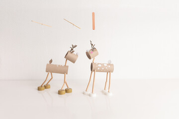 Wall Mural - Christmas deer toy made from recycled toilet paper rolls DIY tutorial for kid and kindergarten. Toilet paper roll craft concept with easy recycle art steps for holiday decorations and crafts,