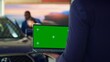 © DC Studio - Salesperson using isolated screen laptop to present car addons options to clients, persuading them to buy. Showroom agent offers extended warranty to customers, holding chroma key notebook, camera A