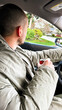 © tessy morelli/Stocksy - UGC man driving holding a can