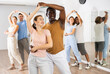 © JackF - Positive people dancing together slow ballroom dances in pairs in choreography class