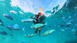 © Gemma can fly/Stocksy - Young girl swimming with fish