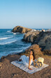 © Manu Padilla/Stocksy - Woman relaxing by cliffside