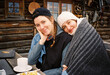 © Volya Tarasava/Stocksy - Portrait of young smiling women at the table outdoors
