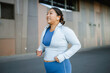 © DZ FILM/Stocksy - A woman is jogging outdoors