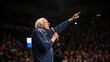 © Justlight - The retiree passionately gestures upward as he discusses future possibilities. His expression is one of fervor painted against the backdrop of a cheering audience. The lights dim