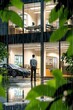 © PLE.POD - Man Standing Outside Modern Office Building in Rain