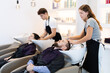 © JackF - Young female hairdresser stylist washing hair of young male client in beauty salon