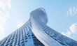 © Evo - A futuristic architectural structure with a twisting design against the sky.