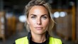 © EZZYECODE - Confident female worker portrait warehouse environment professional photography industrial setting close-up view empowerment in action