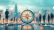 © Nano Photos - Team Leadership :A compass stands prominently in focus amidst a blurred urban background, symbolizing guidance and direction in the bustling cityscape.