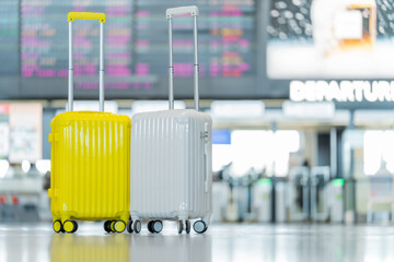 Fototapete - Two suitcases in an empty airport hall, traveler cases in the departure airport terminal waiting for the area, vacation concept, blank space for text message or design, luggage for travel vacation.