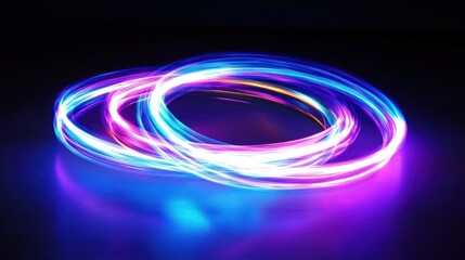 Wall Mural - Abstract glowing neon circles in vibrant blue, pink, and purple light trails on dark background.