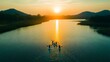© cynz - A storytelling shot of students learning to paddle kayaks on a calm lake during an outdoor adventure activity.