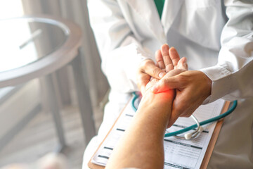 Wall Mural - Doctor holds and examines a patient's wrist, focusing on providing accurate diagnosis and care.Professional medical attention, trust, and the importance of addressing wrist pain or injury.