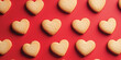 © Tatiana - Heart cookies on red background. Happy Valentine Day background. Generated AI