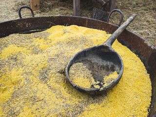 Wall Mural - A large metal bowl filled with yellow grains