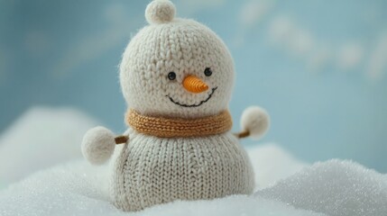 Wall Mural - a cute little knitted snowman on a soft snow background