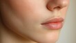 © Suphat - Close-up of a Woman's Face: Soft, natural beauty with a focus on healthy skin, full lips, and a delicate jawline. Perfect for beauty, skincare, or cosmetic advertising.
