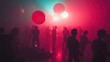 © Cerita - Silhouette of people dancing in a dimly lit club with colorful lights and large balloons.