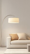 © Halal Vision Studio - Minimalist living room with a light beige sofa, a single oversized floor lamp, and neutral throw pillows