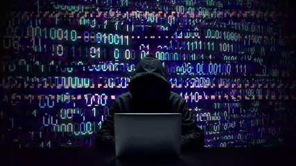 Hacker working on laptop on abstract digital background