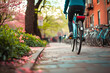 © YouAreBeautiful - Spring Day with Cyclist Using Public Bike Share in City Park