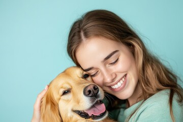 Canvas Print - A woman hugs a happy dog on a bright blue background