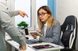 © diy13 - businesswomen suit with boss pointing finger yelling reprove argument sitting on table document report laptop at workplace. the boss gives orders to the subordinate.. Scene tense and confrontational