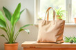 © KRISTINA KUPTSEVICH - Eco-friendly hemp tote bag in natural beige on wooden table surrounded by vibrant green plants. Perfect for promoting sustainable fashion, reusable shopping bags, or organic lifestyle products. Mockup
