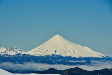 Wall Mural - calbuco vulcano Chile winter snow caped panorama ski mountain blue sky