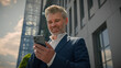 © Yuliia - Caucasian senior middle aged employer mature happy businessman receive message offer opportunity retired business man read good news smartphone excited overjoyed celebrate mobile phone victory in city