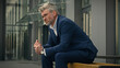 © Yuliia - Stressed middle aged senior adult Caucasian business man suffering feelings sad upset worry anxiety lost failure problem mature male businessman overwork tired employee overwhelmed in city outdoors